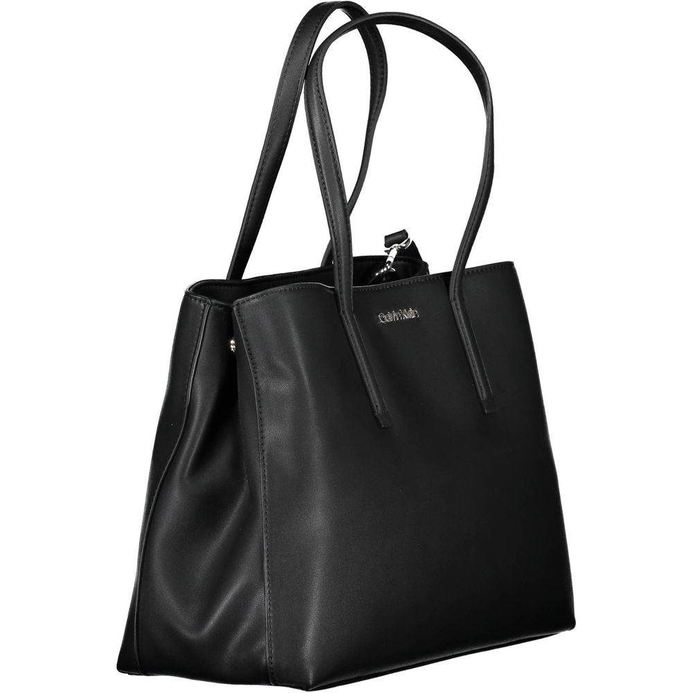 Black Polyester Women HandbagDare to make a statement with the sleek Calvin Klein handbag, designed for the eco-conscious fashionista. Crafted with 100% recycled polyester, it features a versatile dual-handle design complemented by an adjustable and remov