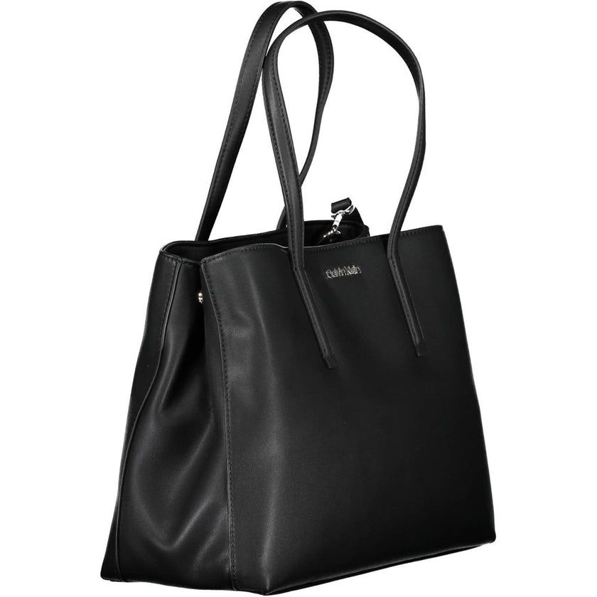 Black Polyester Women HandbagDare to make a statement with the sleek Calvin Klein handbag, designed for the eco-conscious fashionista. Crafted with 100% recycled polyester, it features a versatile dual-handle design complemented by an adjustable and remov