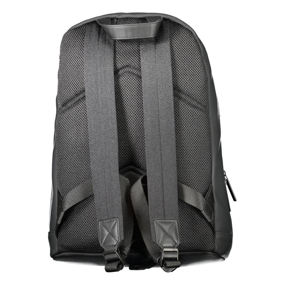 Black Polyester Men BackpackDiscover the epitome of urban sophistication with Calvin Klein’s sleek black backpack, designed for the modern trendsetter. Crafted to perfection with 51% sturdy polyester and a conscious touch of 49% polyethylene, this backpac