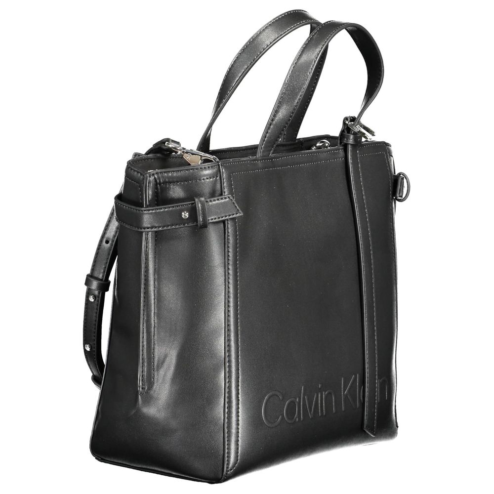 Black Polyester Women HandbagElevate your everyday style with the sophistication of Calvin Klein. This handbag is a testament to sleek aesthetics, featuring a pair of sturdy handles, an adjustable and removable shoulder strap for versatile carrying option