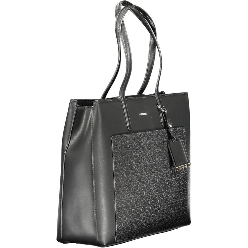Black Polyester Women HandbagElevate your accessory edit with the exquisite Calvin Klein handbag, a masterpiece of both form and function. It boasts dual shoulder straps for ease of carry, a chic external pocket, and multiple compartments that ensure all
