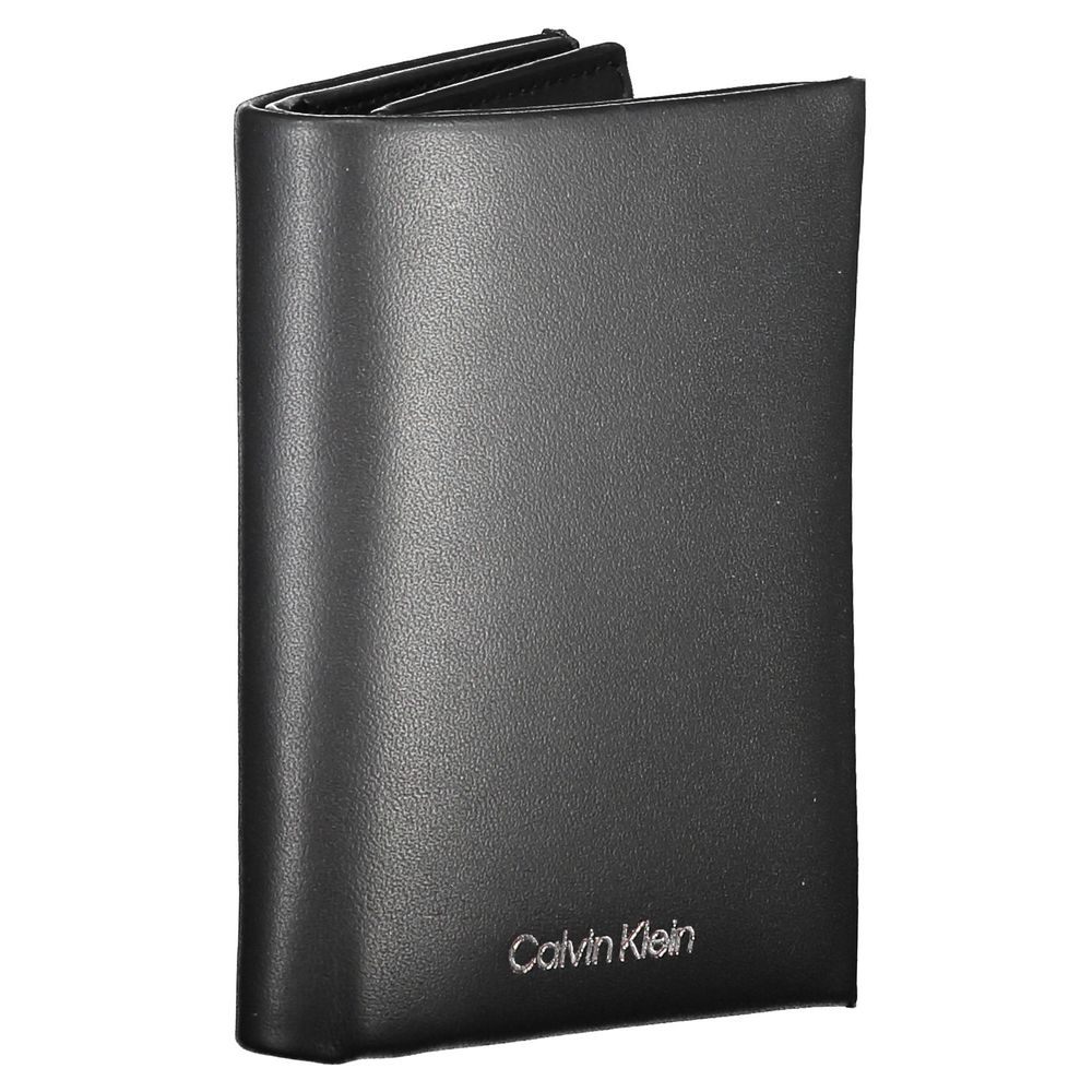Black Leather Men WalletStep into the epitome of timeless elegance with Calvin Klein’s sleek black wallet. Engineered for both style and security, this accessory boasts a sophisticated leather construction that ensures durability and a luxurious feel. Wit