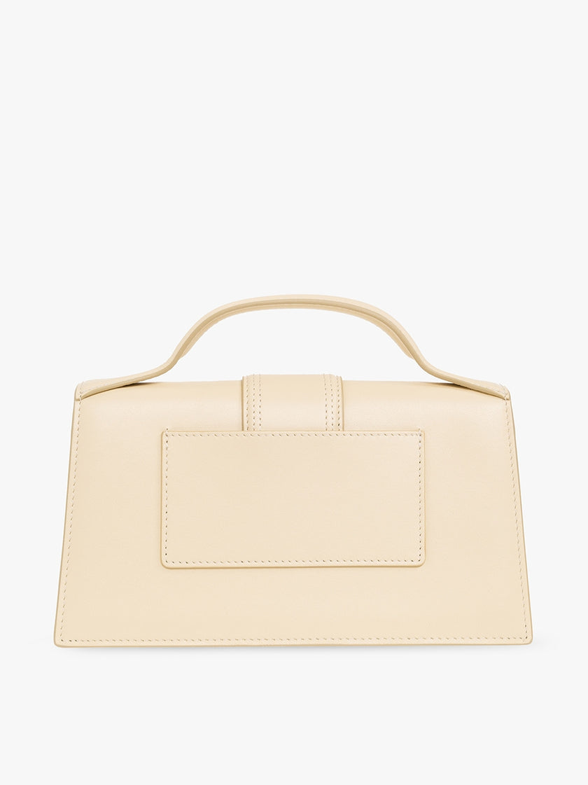 Le Grand Bambino Beige BagJACQUEMUS Gorgeous brand new, 100% Authentic Jacquemus Le Grand Bambino Beige Bag. Model: 213BA007-3060-120 Color: Beige with Gold Hardware Material: Leather Beige with adjustable shoulder strap – Small handle – Removable shoulde