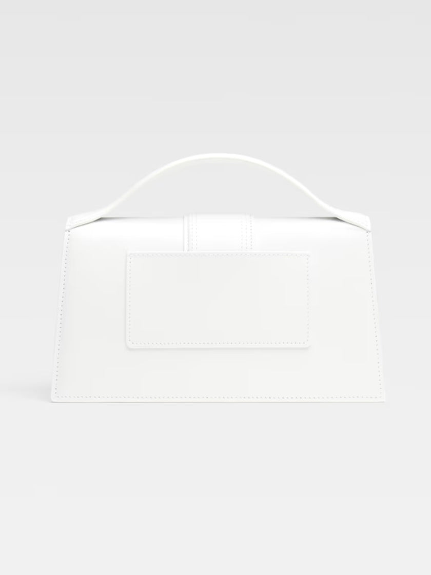 Le Grand Bambino White BagJACQUEMUS Gorgeous brand new, 100% Authentic Jacquemus Le Grand Bambino White Bag. Model: 213BA007-3000-100 Color: White with Gold Hardware Material: Leather – Adjustable shoulder strap – Small handle – Removable shoulder strap –