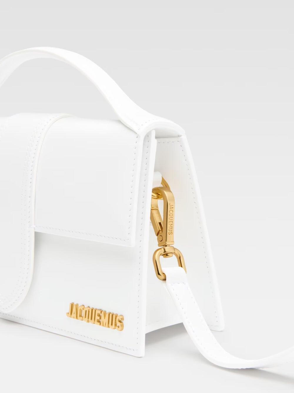Le Grand Bambino White BagJACQUEMUS Gorgeous brand new, 100% Authentic Jacquemus Le Grand Bambino White Bag. Model: 213BA007-3000-100 Color: White with Gold Hardware Material: Leather – Adjustable shoulder strap – Small handle – Removable shoulder strap –