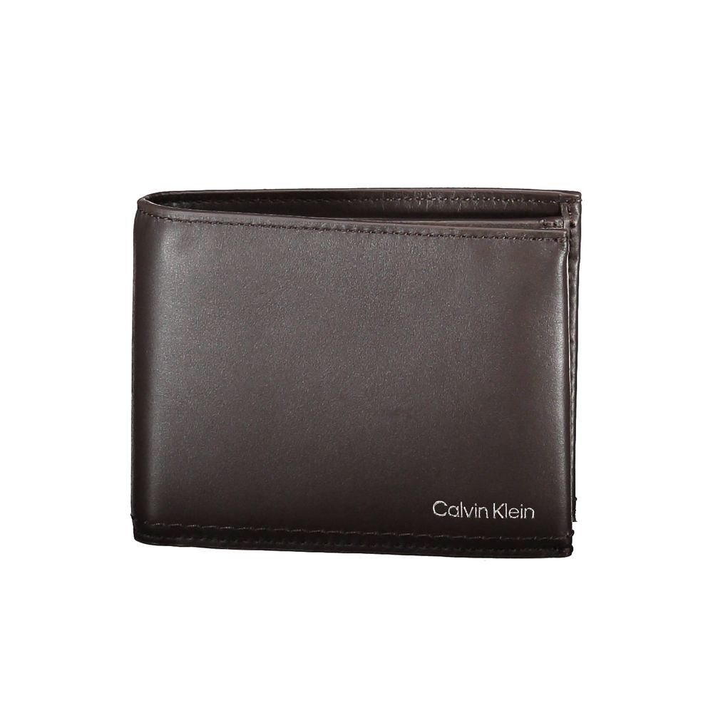 Brown Leather Men WalletElevate your essentials with this sleek Calvin Klein wallet, crafted to perfection from 100% leather in a timeless brown hue. With two spacious compartments and a coin purse, it features ample storage for your monetary needs. Sophi