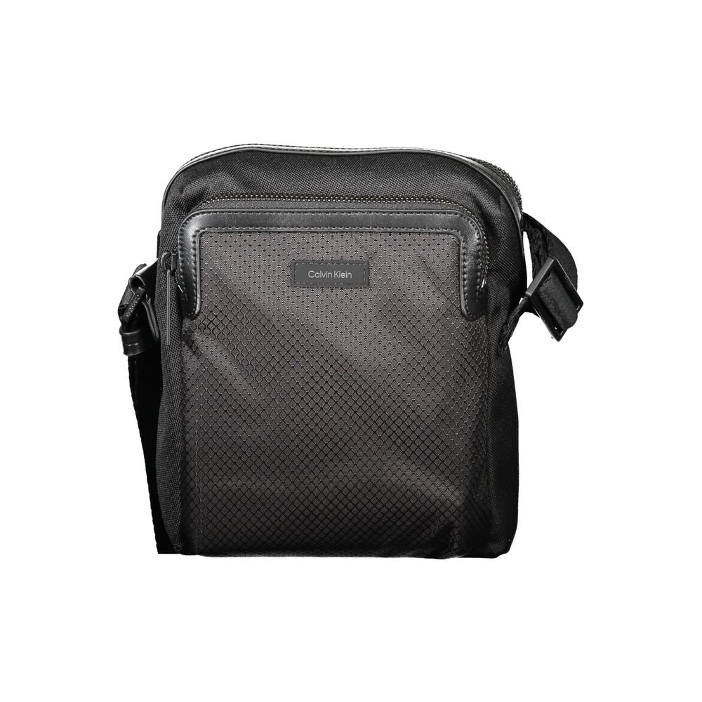 Black Polyester Men Shoulder BagElevate your accessory game with the sleek Calvin Klein Shoulder Bag — where functionality meets minimalist luxury. This piece boasts a sharp black hue enhanced by contrasting details for that touch of edge. Equipped with a