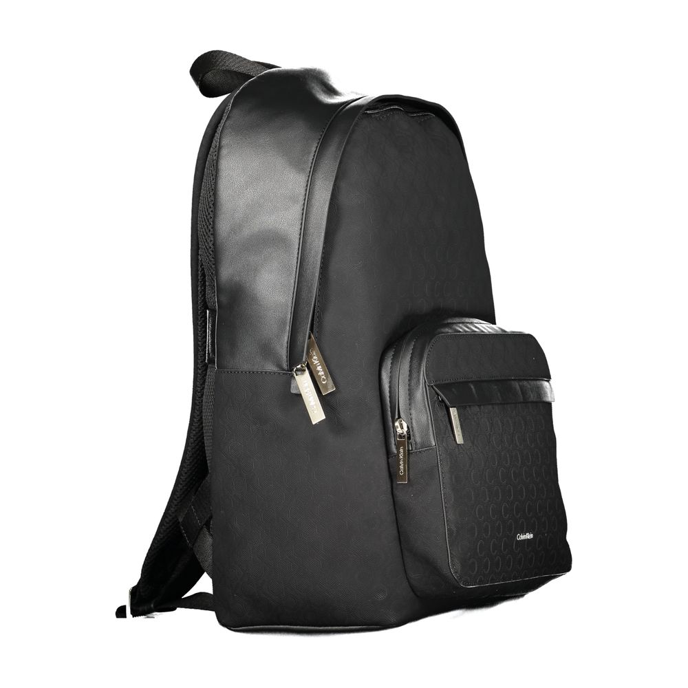 Black Polyester Men BackpackElevate your style to new heights with this sleek Calvin Klein backpack, where functionality meets fashion in a symphony of elegance. Designed for the modern urbanite, it features an external pocket for easy access, a dedicated