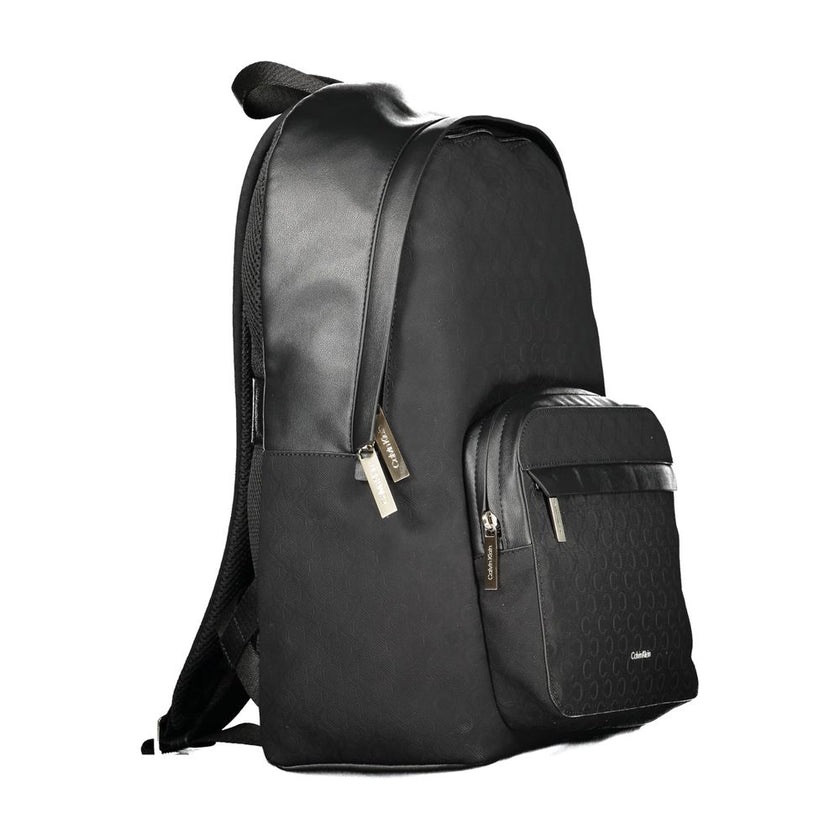 Black Polyester Men BackpackElevate your style to new heights with this sleek Calvin Klein backpack, where functionality meets fashion in a symphony of elegance. Designed for the modern urbanite, it features an external pocket for easy access, a dedicated