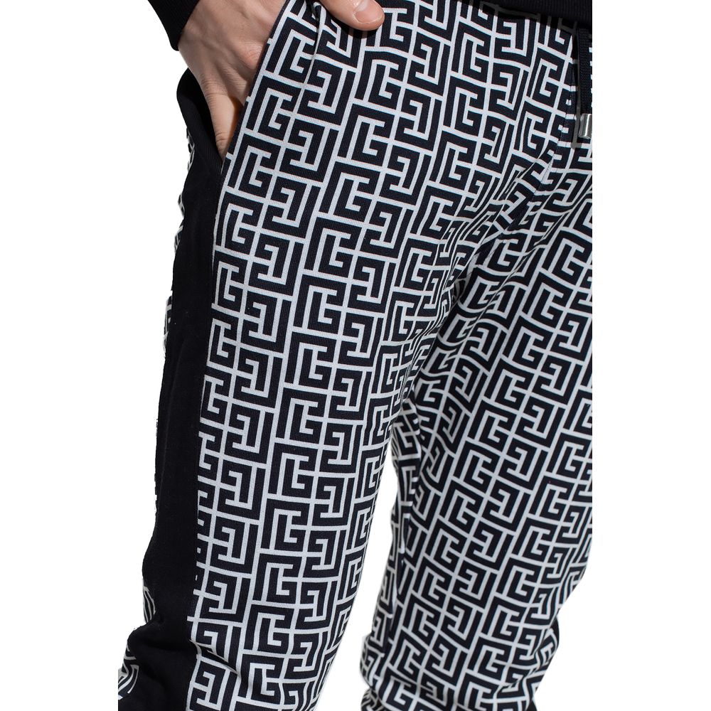 Black Cotton Men SweatpantElevate your off-duty repertoire with the Balmain cotton sweatpants, where casual meets couture. These pants feature a stark white-on-black Greek pattern print that stands out with audacity, while their drawstring and elasticated