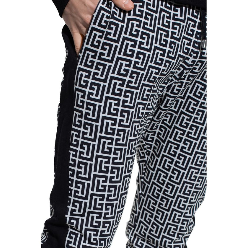 Black Cotton Men SweatpantElevate your off-duty repertoire with the Balmain cotton sweatpants, where casual meets couture. These pants feature a stark white-on-black Greek pattern print that stands out with audacity, while their drawstring and elasticated