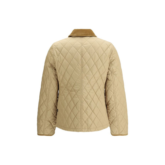 Quilted JacketBurberry’s Quilted Jacket is made of lightweight nylon with a cotton twill interior decorated with the classic Burberry Check pattern in sand color. The model has a slim fit and features tone-on-tone corduroy collar and trim for a refined, u