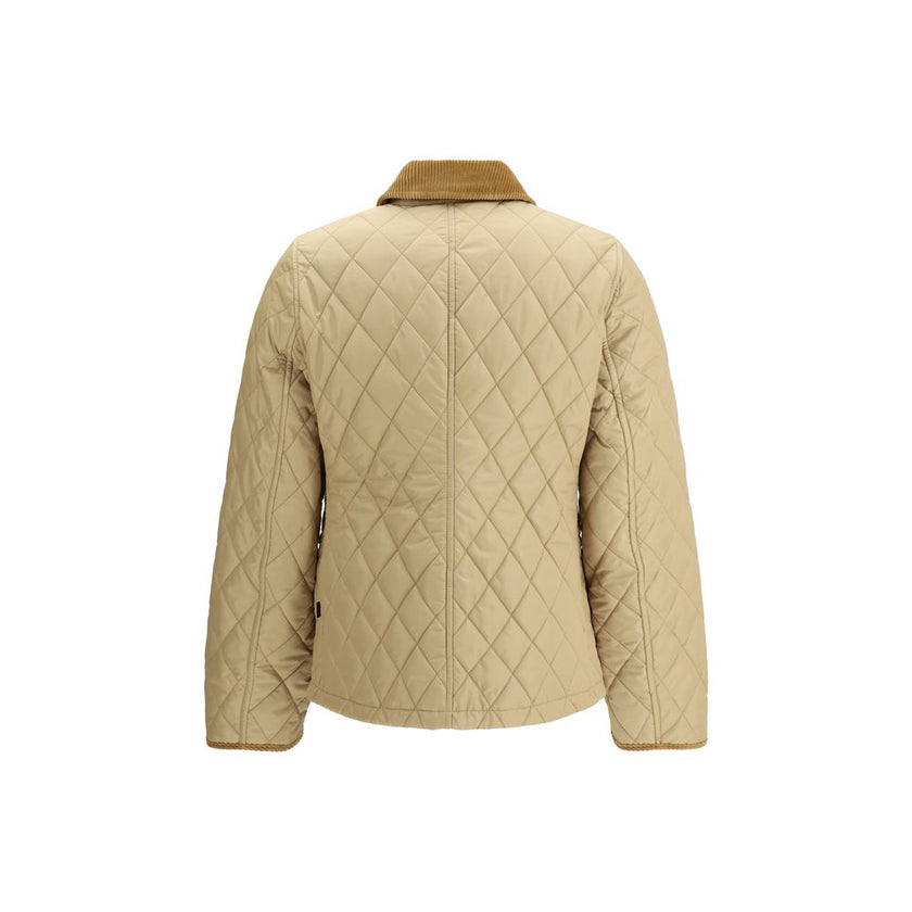Quilted JacketBurberry’s Quilted Jacket is made of lightweight nylon with a cotton twill interior decorated with the classic Burberry Check pattern in sand color. The model has a slim fit and features tone-on-tone corduroy collar and trim for a refined, u