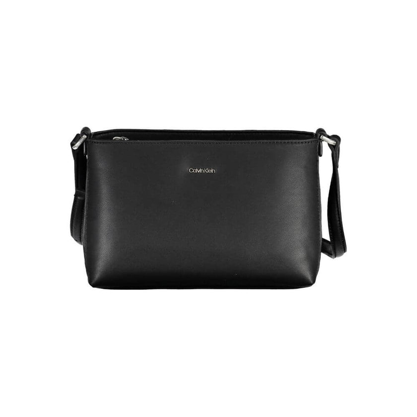 Black Polyester Women HandbagMake a bold statement wherever you go with the Calvin Klein adjustable shoulder bag. Crafted for the modern trendsetter, this sleek black handbag boasts a minimalist design with a pronounced logo, combining functionality with