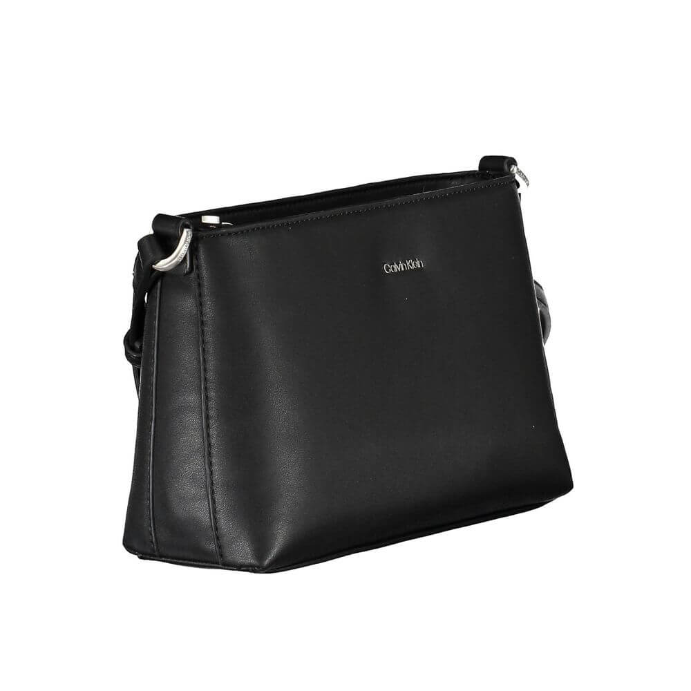 Black Polyester Women HandbagMake a bold statement wherever you go with the Calvin Klein adjustable shoulder bag. Crafted for the modern trendsetter, this sleek black handbag boasts a minimalist design with a pronounced logo, combining functionality with
