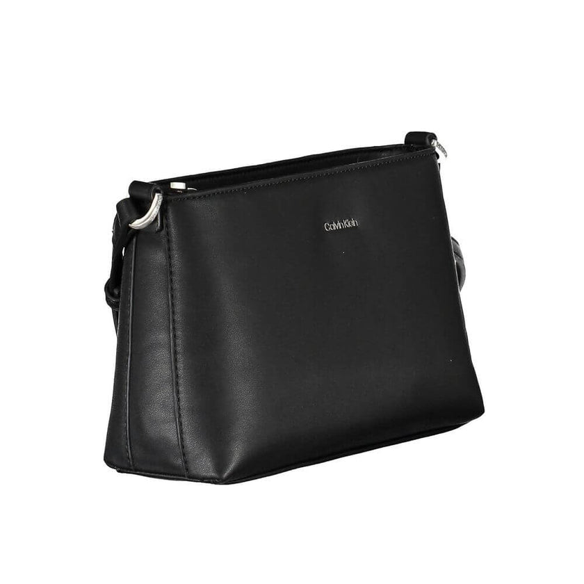 Black Polyester Women HandbagMake a bold statement wherever you go with the Calvin Klein adjustable shoulder bag. Crafted for the modern trendsetter, this sleek black handbag boasts a minimalist design with a pronounced logo, combining functionality with