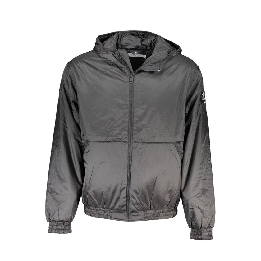Black Recycled Polyester Men JacketElevate your outerwear collection with the sleek Calvin Klein Long Sleeved Jacket – where sophistication meets sustainability. Crafted from 100% recycled polyester, this hooded marvel balances environmental consciousness