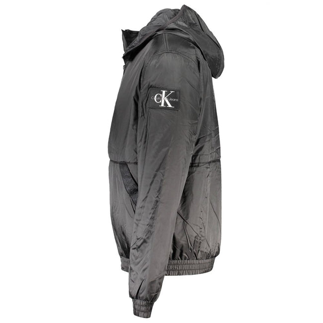 Black Recycled Polyester Men JacketElevate your outerwear collection with the sleek Calvin Klein Long Sleeved Jacket – where sophistication meets sustainability. Crafted from 100% recycled polyester, this hooded marvel balances environmental consciousness