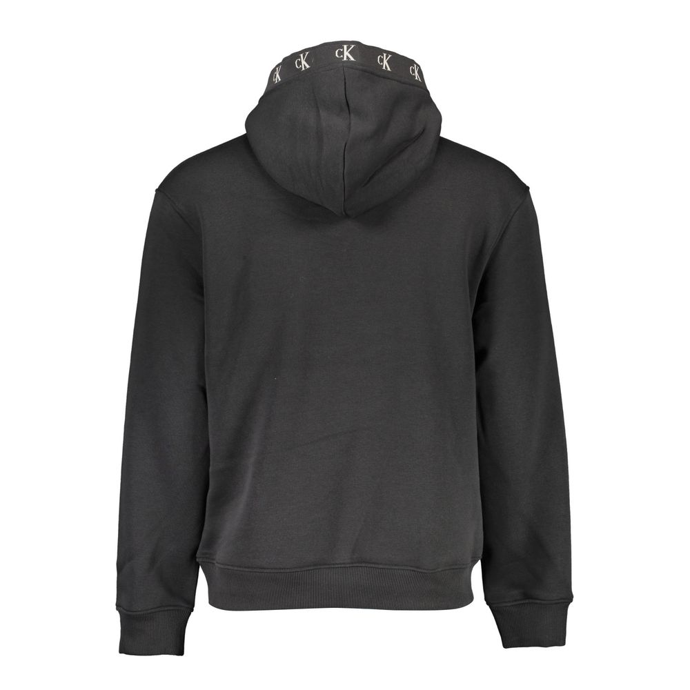 Black Cotton Men SweaterRevamp your style with the audacious edge of Calvin Klein. This sleek black hoodie is a masterclass in casual luxury, merging comfort with emblematic flair. The long sleeves, central pocket, and striking contrasting details radiate