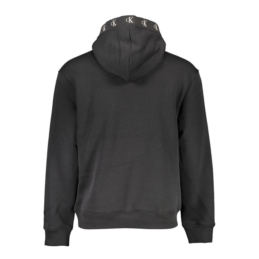 Black Cotton Men SweaterRevamp your style with the audacious edge of Calvin Klein. This sleek black hoodie is a masterclass in casual luxury, merging comfort with emblematic flair. The long sleeves, central pocket, and striking contrasting details radiate