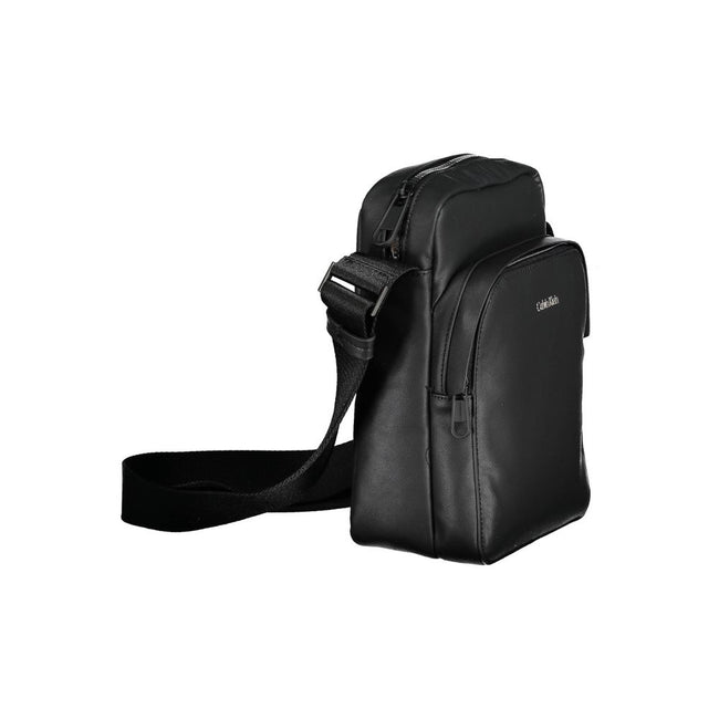 Black Polyester Men Shoulder BagExperience the pinnacle of functional style with this sleek Calvin Klein shoulder bag. Crafted from eco-conscious materials for the modern trendsetter, this bag boasts a bold black hue accentuated by contrasting details tha