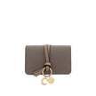 Gray Calf Leather Bos Taurus WalletAlphabet by Chloé Wallet in grained leather, elegant and functional. Featuring a charm detail that adds a touch of personality, it has a snap-button closure for security and convenience. Inside, it features a main compar