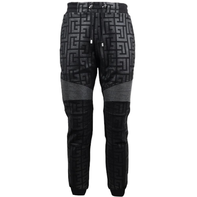 Black Cotton Men Jogging PantStep into the ultimate fusion of comfort and high-fashion with these Balmain black cotton jogging pants. Flaunting a bold all-over pattern print that ensures you’ll stand out in any crowd, these joggers are an essential update