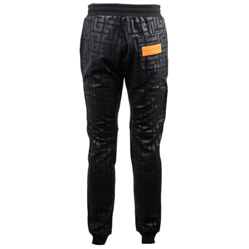 Black Cotton Men Jogging PantStep into the ultimate fusion of comfort and high-fashion with these Balmain black cotton jogging pants. Flaunting a bold all-over pattern print that ensures you’ll stand out in any crowd, these joggers are an essential update