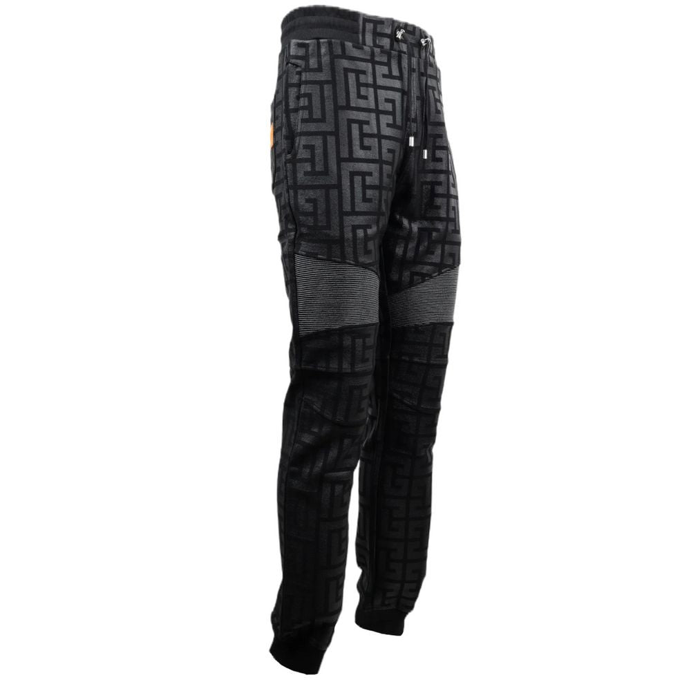 Black Cotton Men Jogging PantStep into the ultimate fusion of comfort and high-fashion with these Balmain black cotton jogging pants. Flaunting a bold all-over pattern print that ensures you’ll stand out in any crowd, these joggers are an essential update