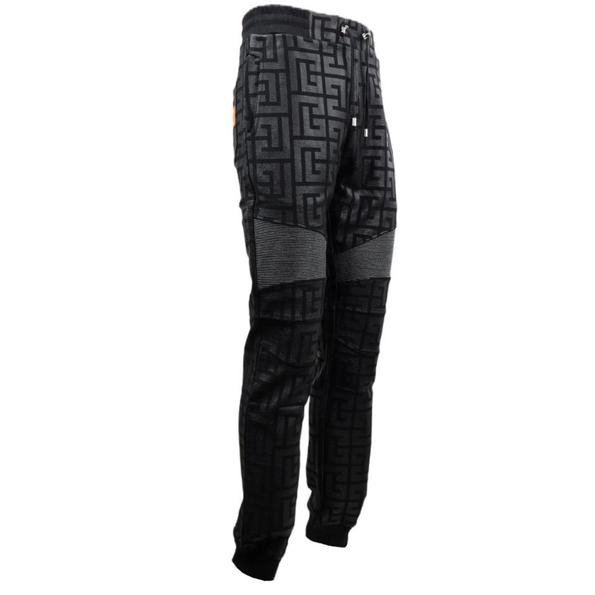 Black Cotton Men Jogging PantStep into the ultimate fusion of comfort and high-fashion with these Balmain black cotton jogging pants. Flaunting a bold all-over pattern print that ensures you’ll stand out in any crowd, these joggers are an essential update