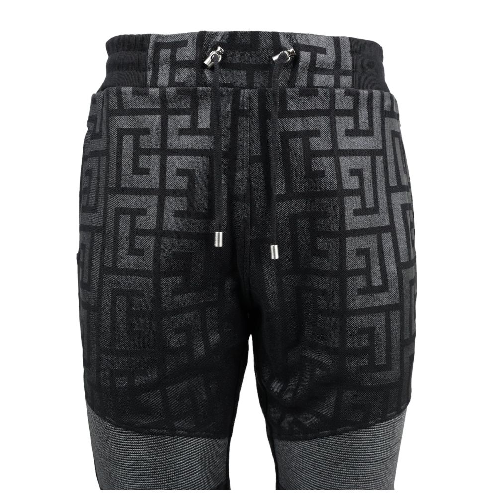 Black Cotton Men Jogging PantStep into the ultimate fusion of comfort and high-fashion with these Balmain black cotton jogging pants. Flaunting a bold all-over pattern print that ensures you’ll stand out in any crowd, these joggers are an essential update