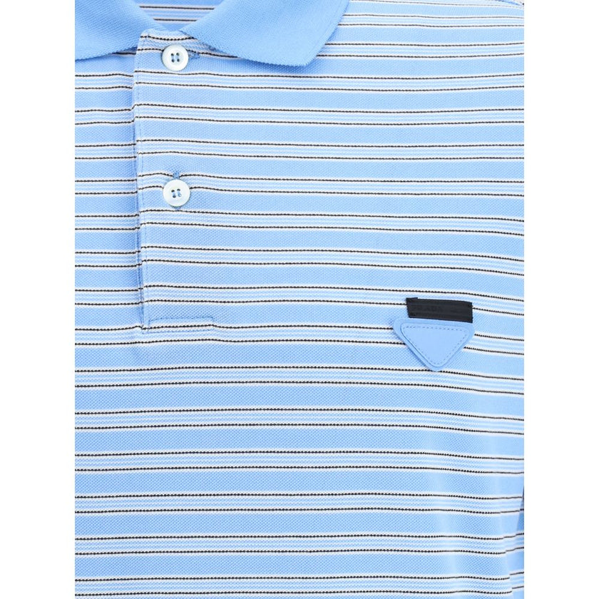 Light Blue Cotton Polo ShirtPrada’s Striped Polo Sweater combines a sporty style with the Maison’s iconic details. With a classic collar and three-button front closure, it is embellished with the unmistakable triangular patch on the front and a signature
