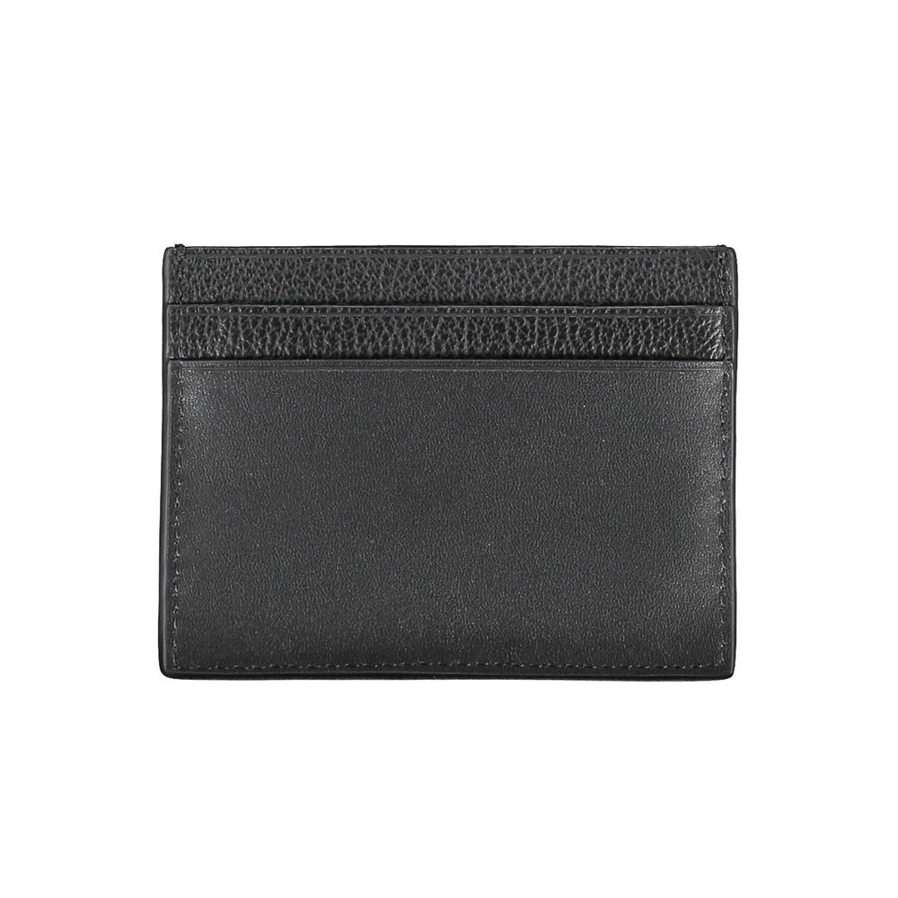 Elegant Leather Card Holder in Timeless BlackStreamline your essentials with this sleek and sophisticated leather card holder from Calvin Klein. Perfect for the minimalist, it features a central pocket designed to hold your cards securely while the iconic