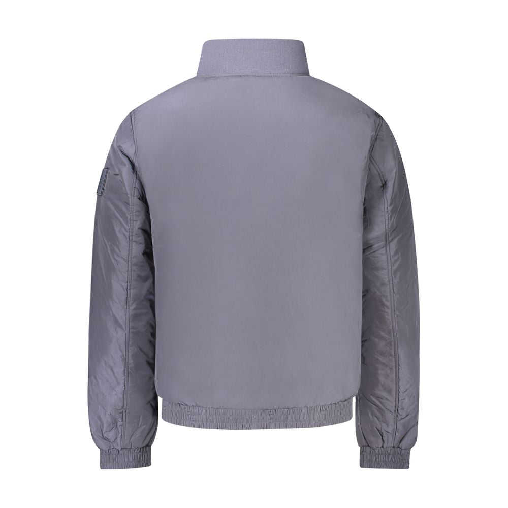Blue Polyamide Men JacketEmbrace the cutting-edge design of Calvin Klein with this sleek long sleeve jacket. A fashion-forward choice for the modern trendsetter, this piece is crafted to command attention. It features a distinct zip closure and is adorned