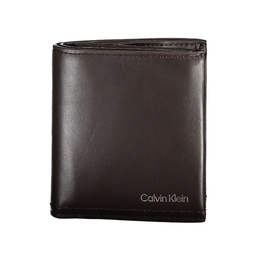 Brown Leather Men WalletElevate your daily essentials with this sleek Calvin Klein wallet, crafted from the finest 100% leather to ensure durability with a touch of sophistication. Featuring two spacious compartments, a handy coin purse, and ample slots f