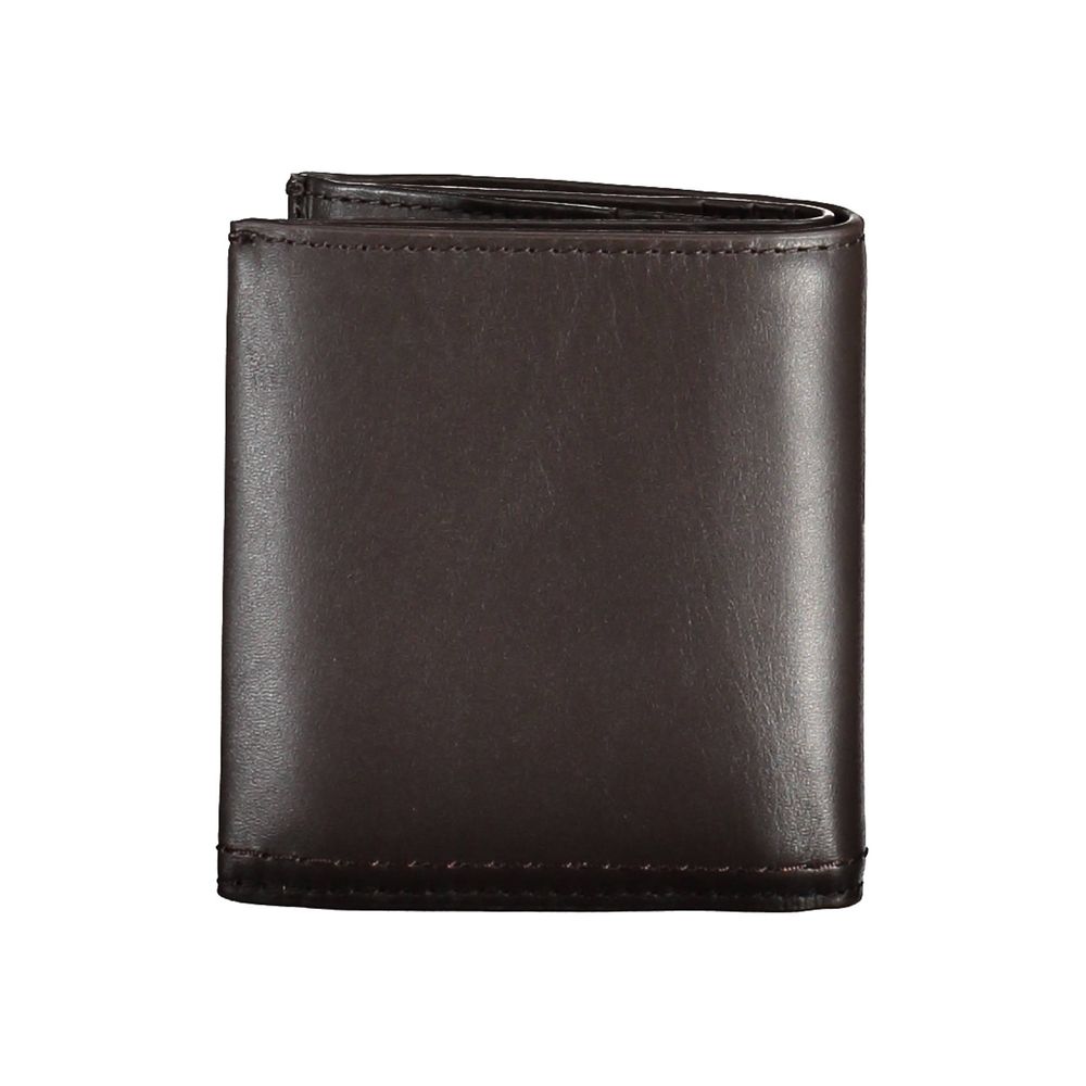 Brown Leather Men WalletElevate your daily essentials with this sleek Calvin Klein wallet, crafted from the finest 100% leather to ensure durability with a touch of sophistication. Featuring two spacious compartments, a handy coin purse, and ample slots f