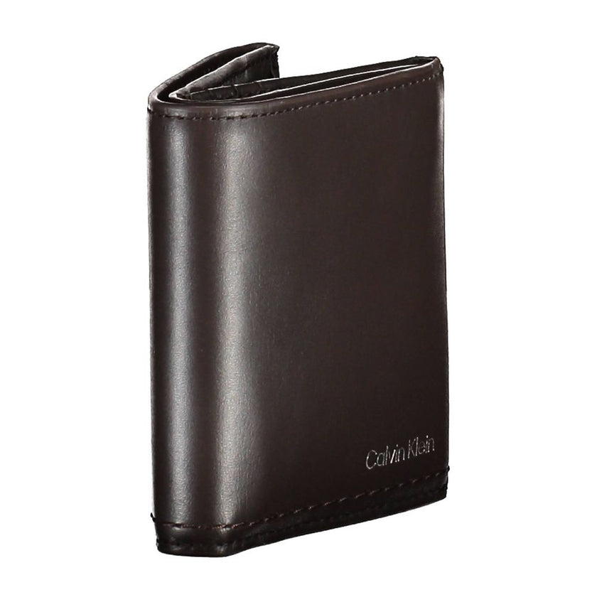 Brown Leather Men WalletElevate your daily essentials with this sleek Calvin Klein wallet, crafted from the finest 100% leather to ensure durability with a touch of sophistication. Featuring two spacious compartments, a handy coin purse, and ample slots f