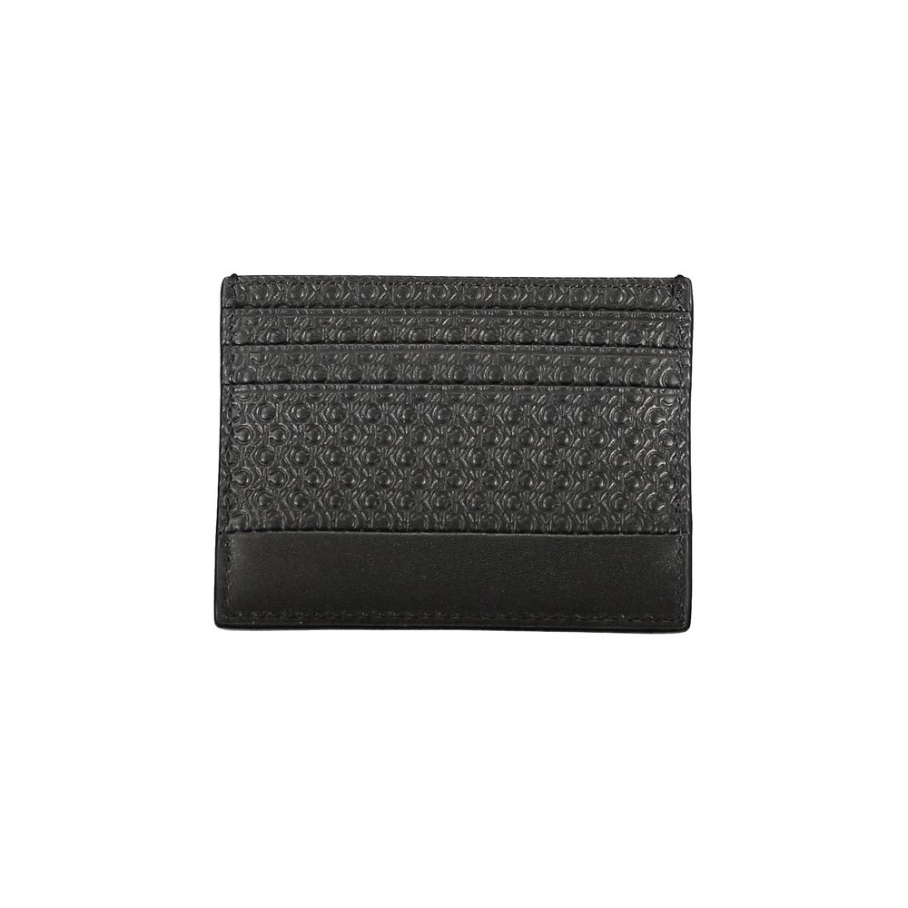 Sleek Black Contrast Card HolderEmbrace the epitome of modern sophistication with this sleek Calvin Klein card holder. Designed for the minimalist who appreciates a touch of elegance, this accessory boasts a central pocket lined with contrast details and