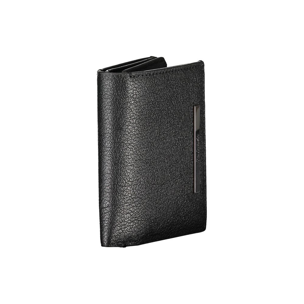 Sleek Black Leather Wallet with Coin PurseDiscover the sophistication of Calvin Klein’s craftsmanship with this sleek black leather wallet. Designed for the modern man, this wallet features two spacious compartments to keep your essentials organized. A co