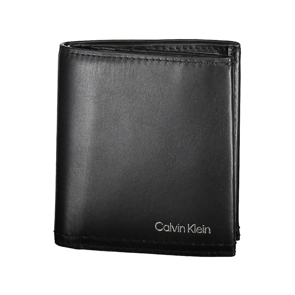Black Leather Men WalletCrafted with the modern gentleman in mind, this Calvin Klein wallet is the epitome of sleek sophistication. A design that resonates with the brand’s minimalist aesthetic, it boasts two spacious compartments, a coin purse tailored f
