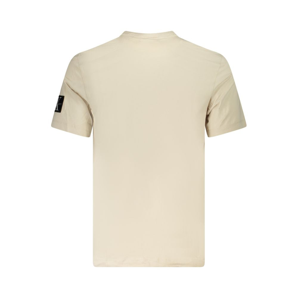 Beige Cotton Men T-ShirtExperience the epitome of sleek fashion with Calvin Klein’s latest creation that seamlessly melds sustainability and style. This short-sleeve T-shirt, with its crisp crew neck and eye-catching contrasting details, showcases the bra