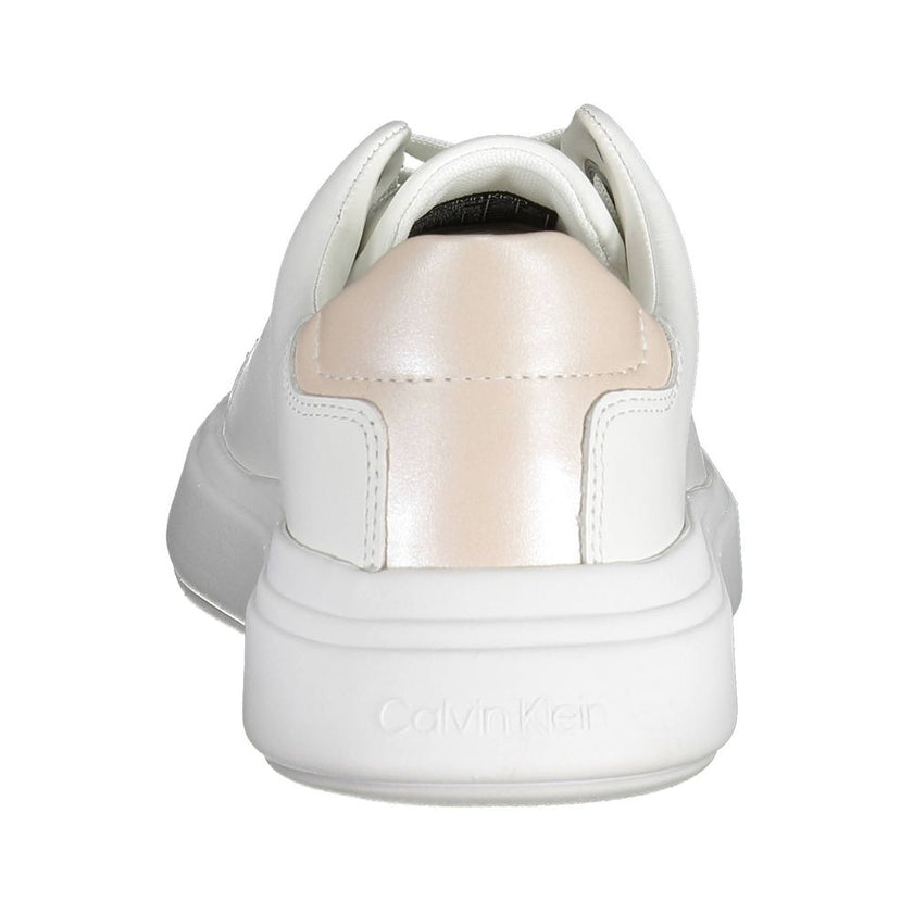 White Leather Women SneakerStep out in elevated style with these Calvin Klein sneakers, where sophistication meets urban chic. Flaunting contrasting details that add a touch of the unexpected, these shoes are emblazoned with the iconic logo, showcasing yo