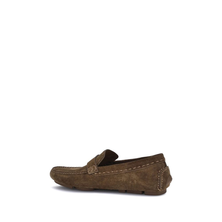 Brown Rubber Slip-On LoafersFendi’s Driver Loafers are made of soft suede and feature a rubber-injected sole for comfort and grip. They feature FF detail and Fendi lettering, while the upper is finished with an elegant metal FF detail with palladium finis
