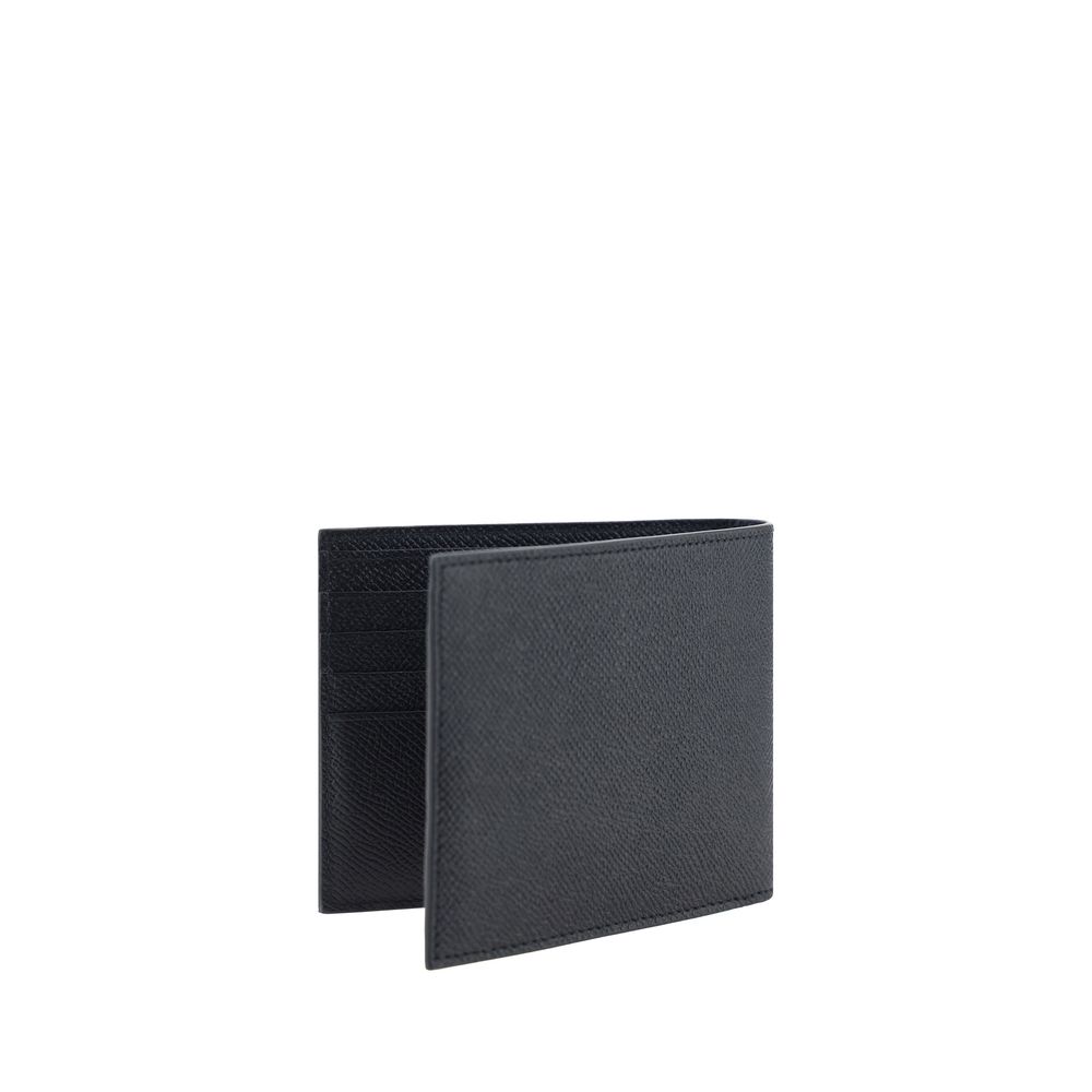 Black Calf Leather Bos Taurus WalletCalfskin Wallet by Ferragamo, billfold model, grained leather design, banknote compartment, interior card slot, iconic brand monogram press-stamped on interior panel, three-dimensional iconic brand Gancini logo plaque a