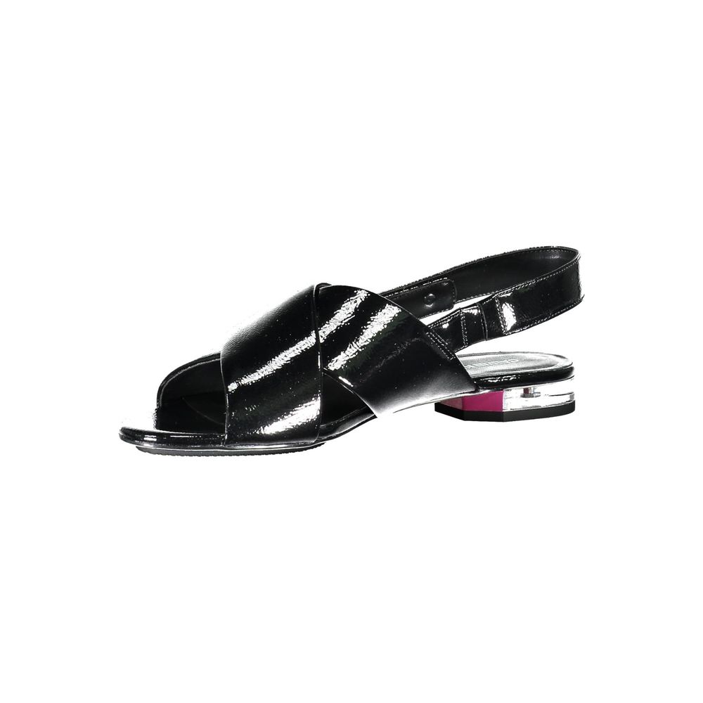 Black Leather Women SandalStep out in style and embrace the epitome of minimalist chic with these Calvin Klein Flat Sandals. Designed for the modern fashionista, they feature a subtle 1cm heel and an elegant crossed front, adorned with the iconic Calvin K