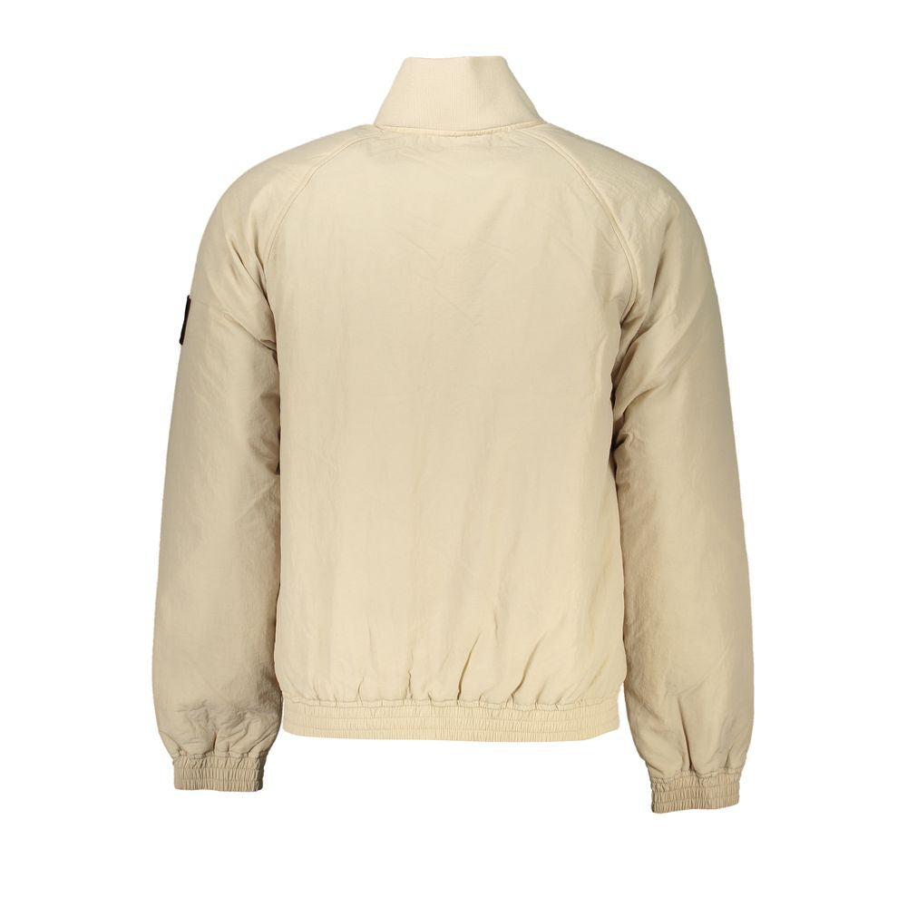 Beige Polyamide Men JacketDare to stand out with the unmistakable allure of Calvin Klein. This beige long-sleeve jacket isn’t just a statement of style, it’s a commitment to sustainability with its recycled fabric. Adorned with a striking print and the ic