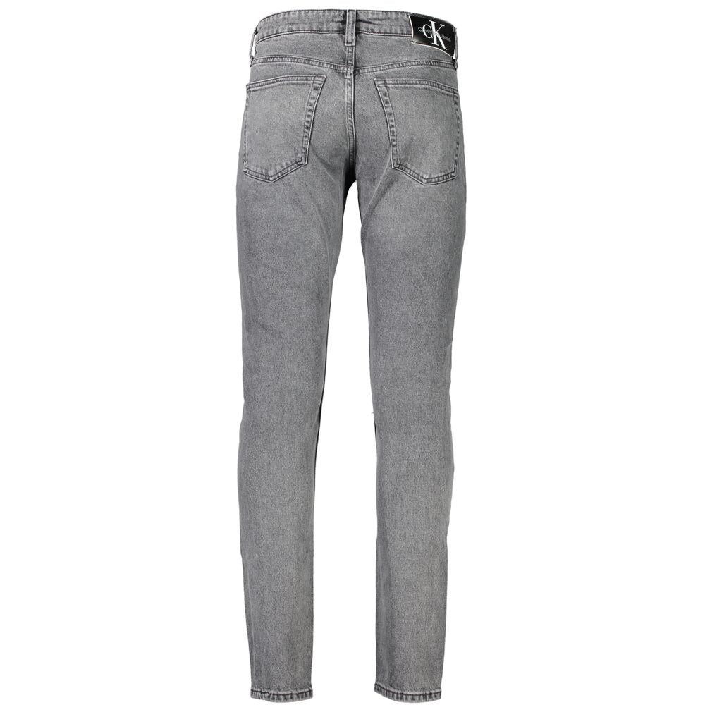 Gray Cotton Men JeansStep into the epitome of sleek sophistication with Calvin Klein’s Slim Taper Jeans. Perfectly engineered to blend style with comfort, these jeans boast an unmatched fit that’s both contemporary and timeless. Made for the modern trends