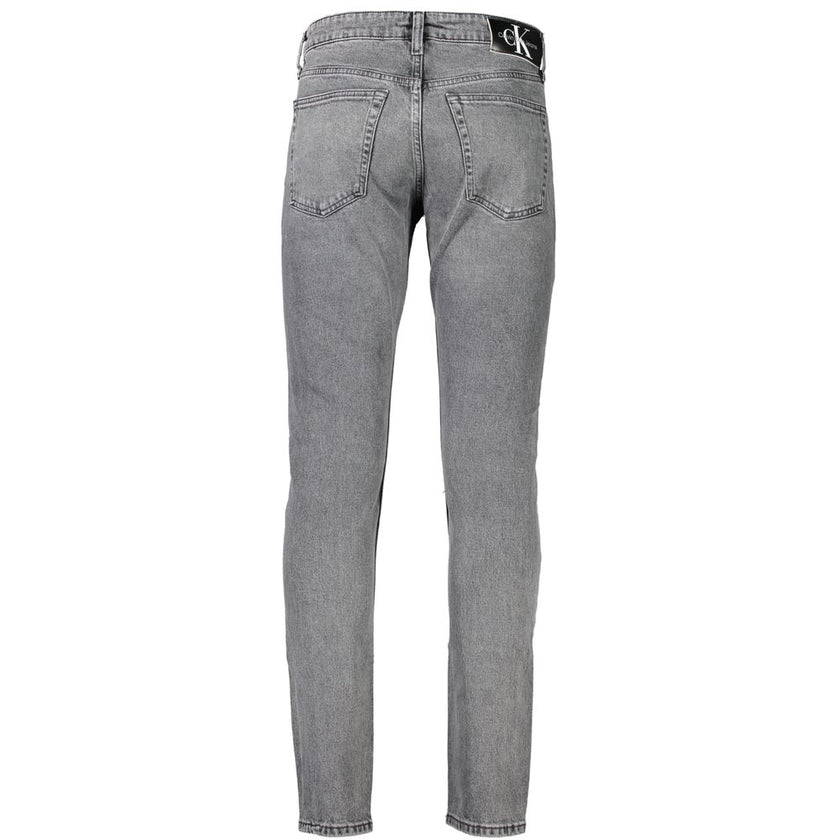 Gray Cotton Men JeansStep into the epitome of sleek sophistication with Calvin Klein’s Slim Taper Jeans. Perfectly engineered to blend style with comfort, these jeans boast an unmatched fit that’s both contemporary and timeless. Made for the modern trends