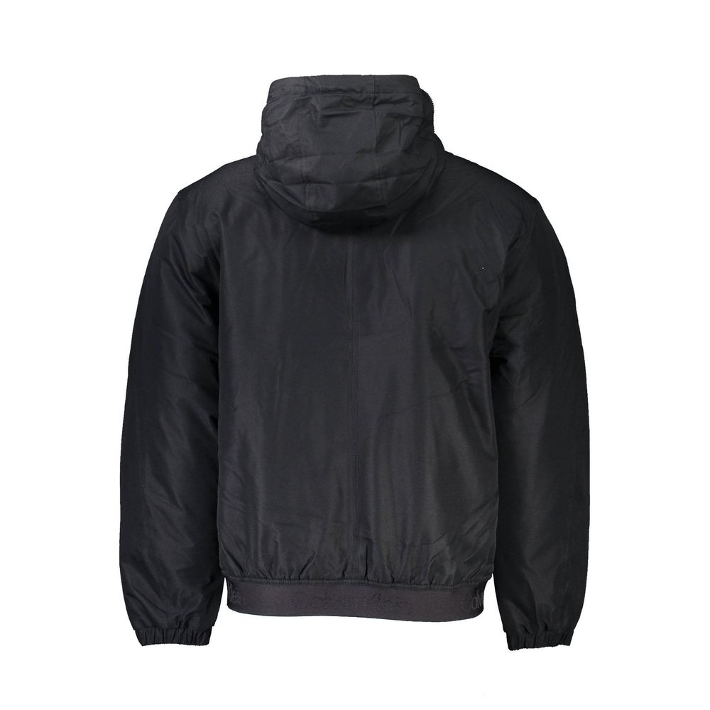 Black Polyester Men JacketInfuse your wardrobe with the sleek sophistication of Calvin Klein’s long-sleeved jacket — an essential for the modern trendsetter. Masterfully crafted to brave the elements, it boasts a removable hood with a zip for versatile st