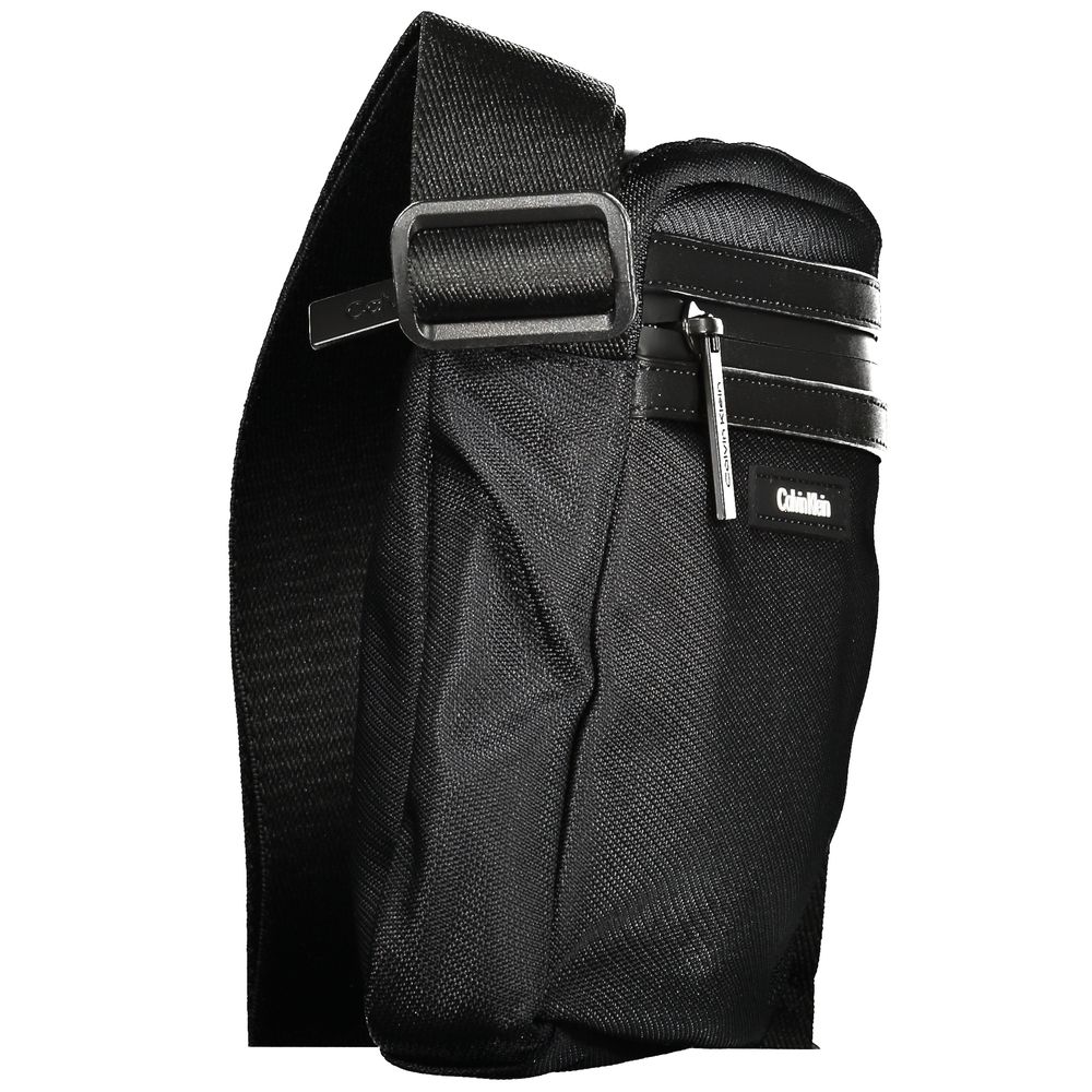 Black Polyester Men Shoulder BagElevate your accessory game with the sophisticated edge of a Calvin Klein shoulder bag, the perfect blend of functionality and sleek style. Boasting adjustable straps for a custom fit, this bag features two convenient exter